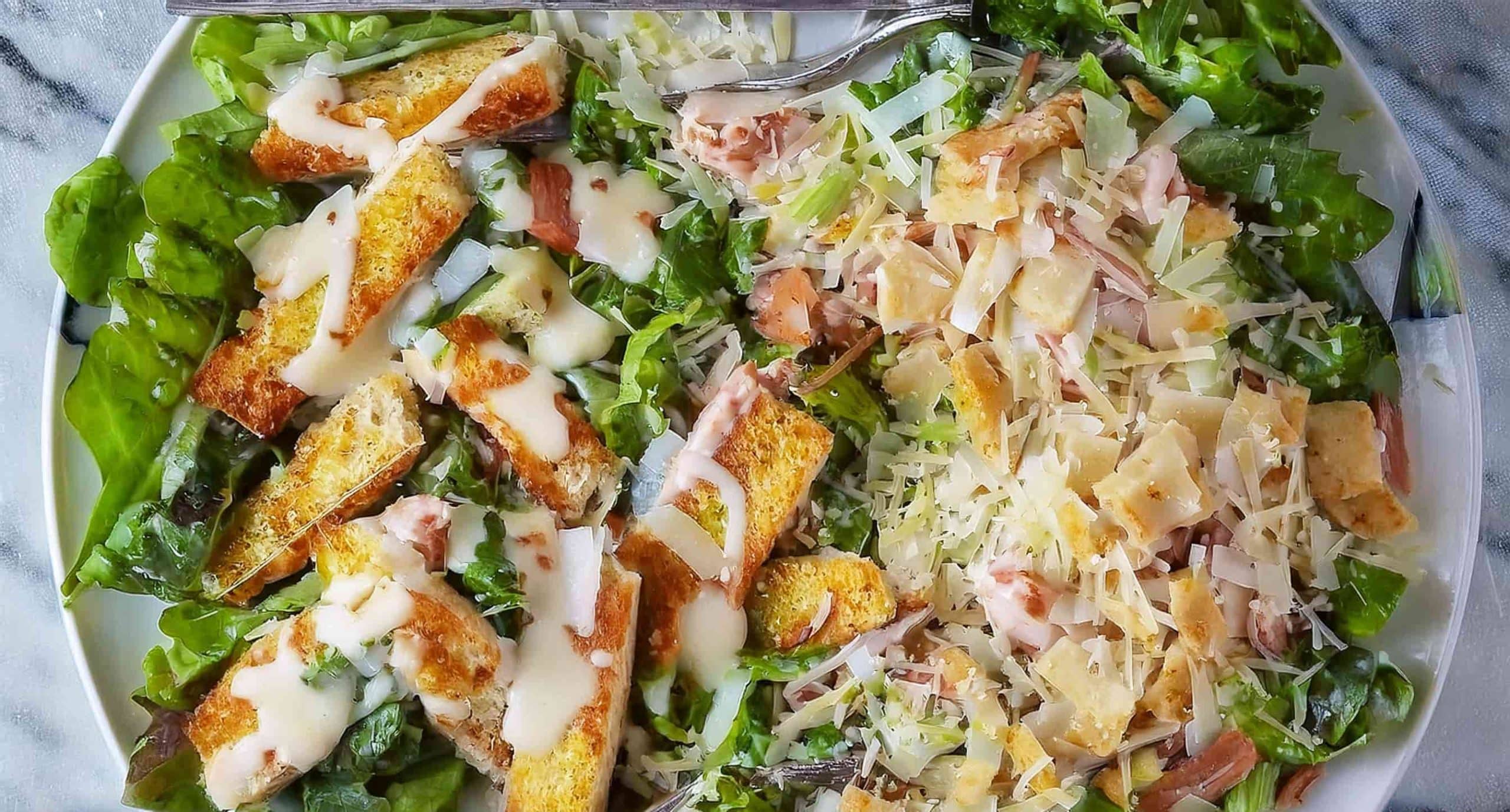 Grilled Caesar chicken served on a bed of crisp romaine lettuce, topped with homemade croutons and Parmesan cheese.