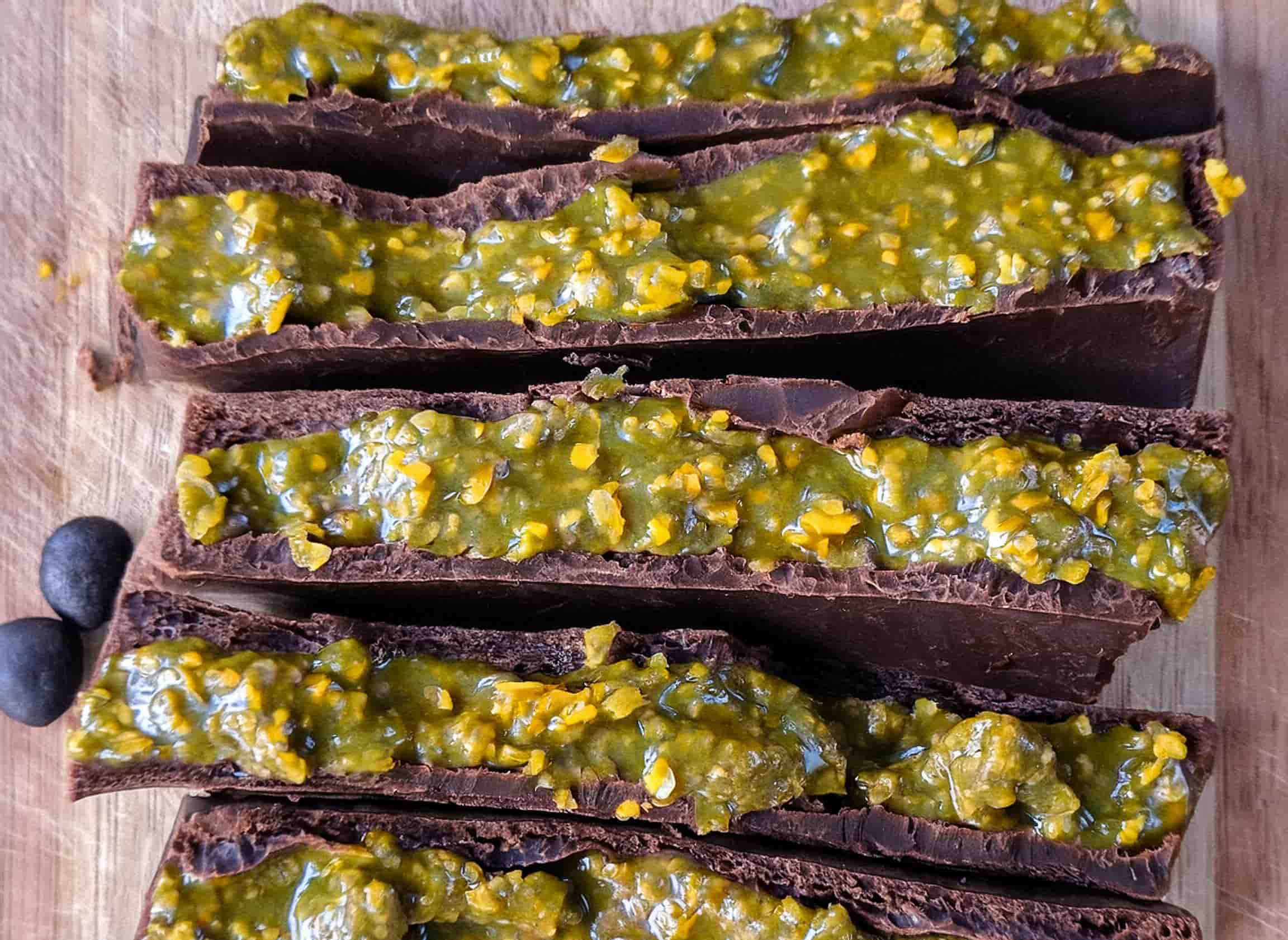 Decadent Dubai chocolate bars with pistachio filling, topped with a delicate drizzle of white chocolate and displayed on a marble tray.