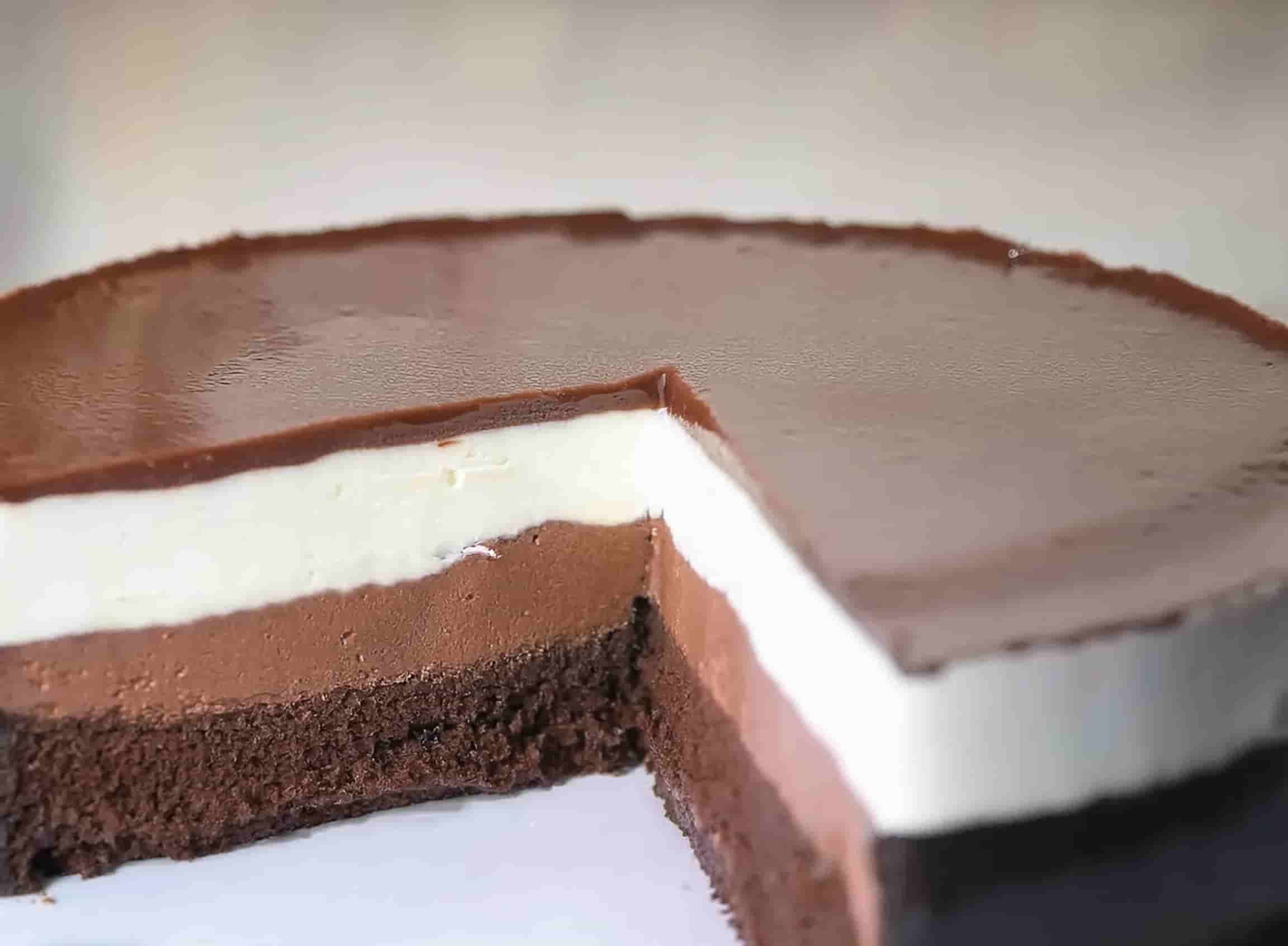 A beautifully crafted Swiss Chocolate Chalet Cake with layered chocolate ganache, decorated with chalet-inspired chocolate sculpture