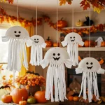 Hanging paper plate ghosts with faces and streamer tails as Halloween décor.