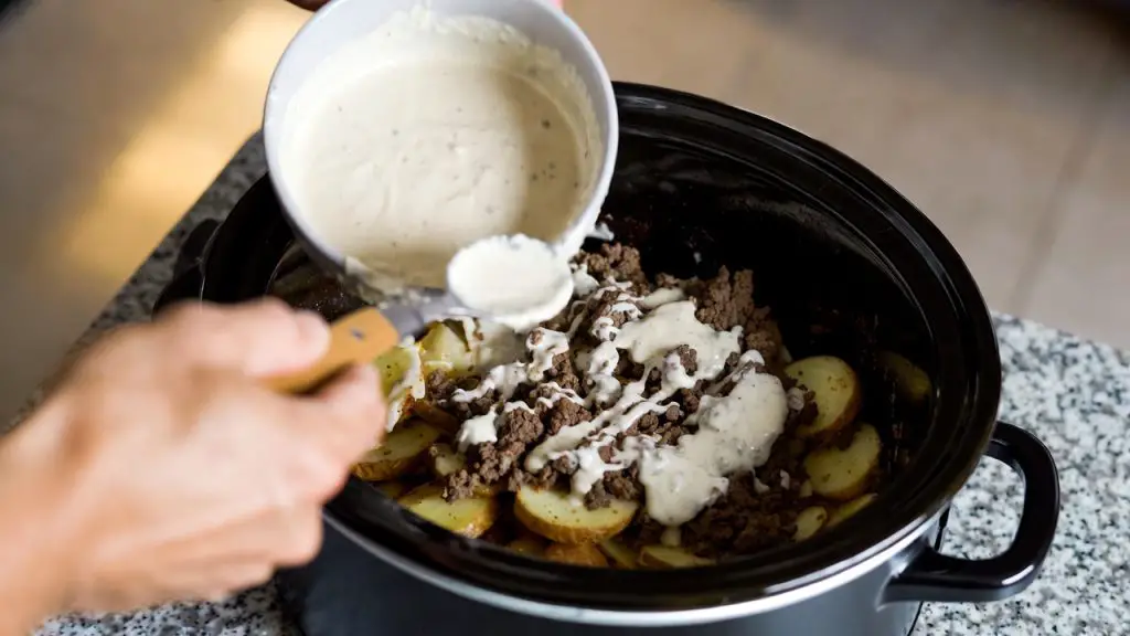 Layering in Crockpot of crockpot hamburger potato casserole